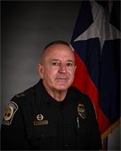 Photo of Former duty photo of Chief Robert "Bob" Wieners with Texas flag behind