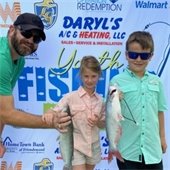 Image of boy and girl with dad holding catfish